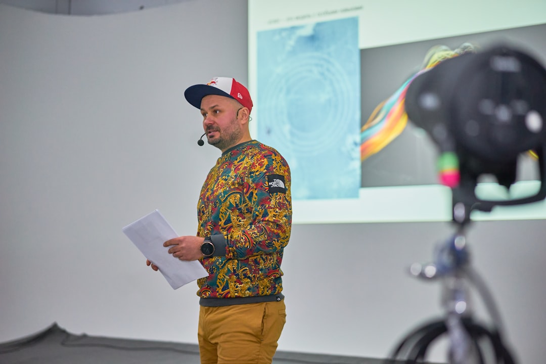 Photo by Valery Tenevoy A man standing in front of a projector screen